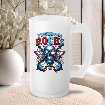 Frosted glass mug with "Freedom Rocks" and skull design against a cozy wooden background with white flowers.