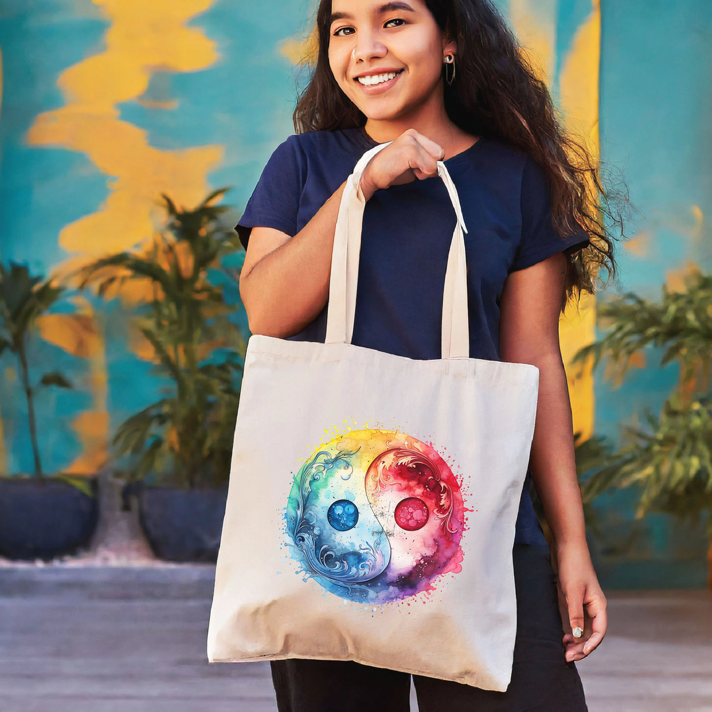 a woman holding a tote bag with a colorful design on it