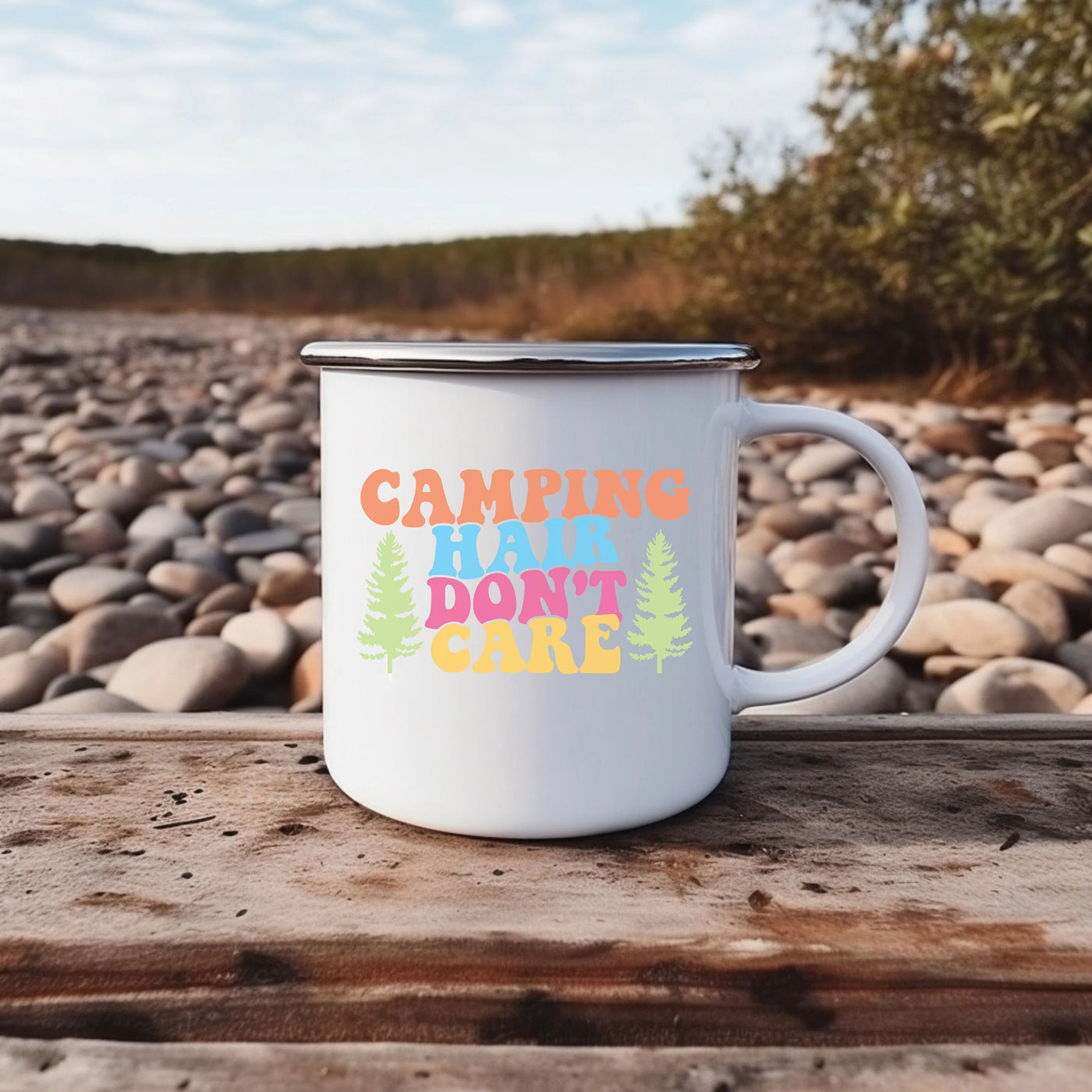 a white camp mug sitting on top of a wooden table