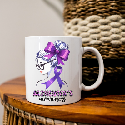 a white coffee mug with a purple ribbon on it