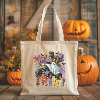 a trick or treat bag sitting on a table next to pumpkins