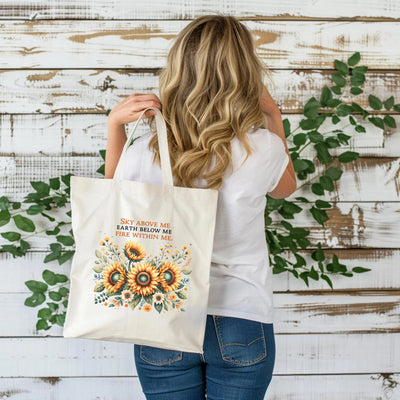 a woman carrying a sunflower tote bag