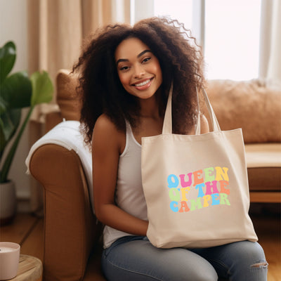 a woman sitting on a couch holding a tote bag