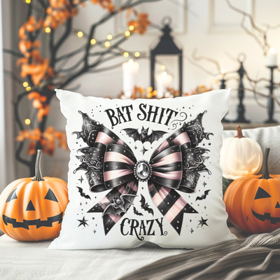 a pillow with a bow on it sitting on a bed