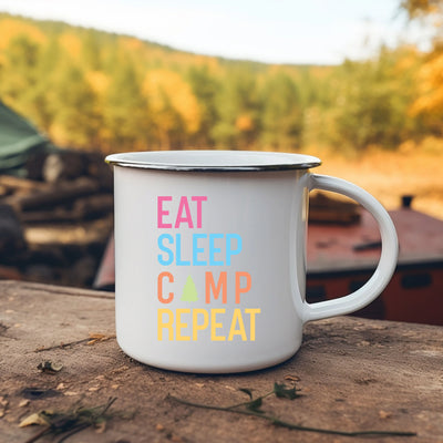 a white camp mug sitting on top of a wooden table