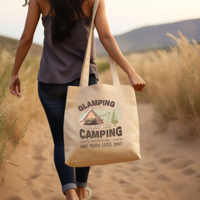 a woman walking down a path carrying a bag