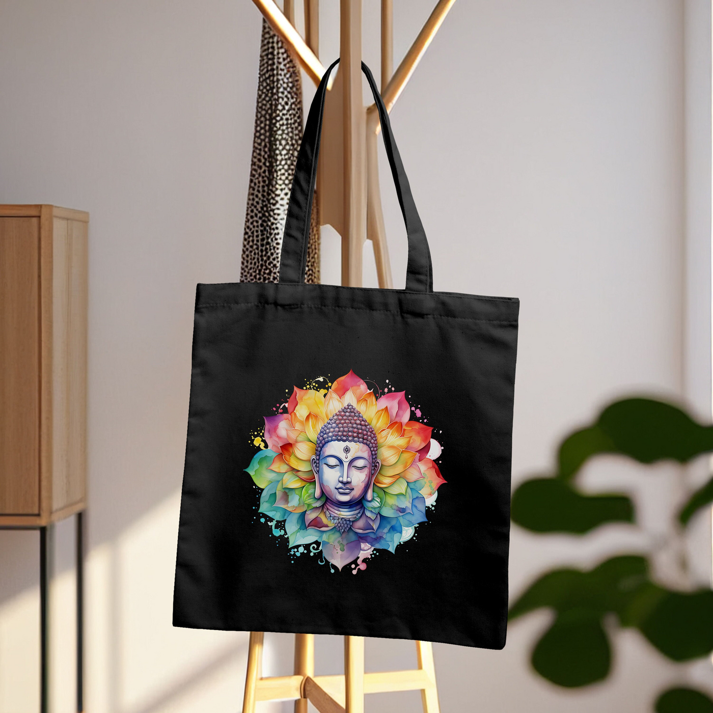 a black tote bag with a buddha image on it