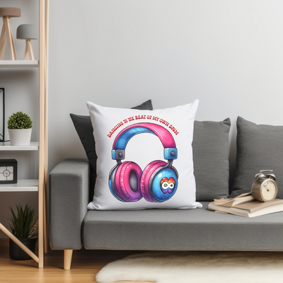 Decorative pillow with colorful headphones graphic on a gray couch in modern living room