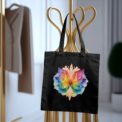 Colorful mandala print on black tote bag hanging on golden stand in modern room