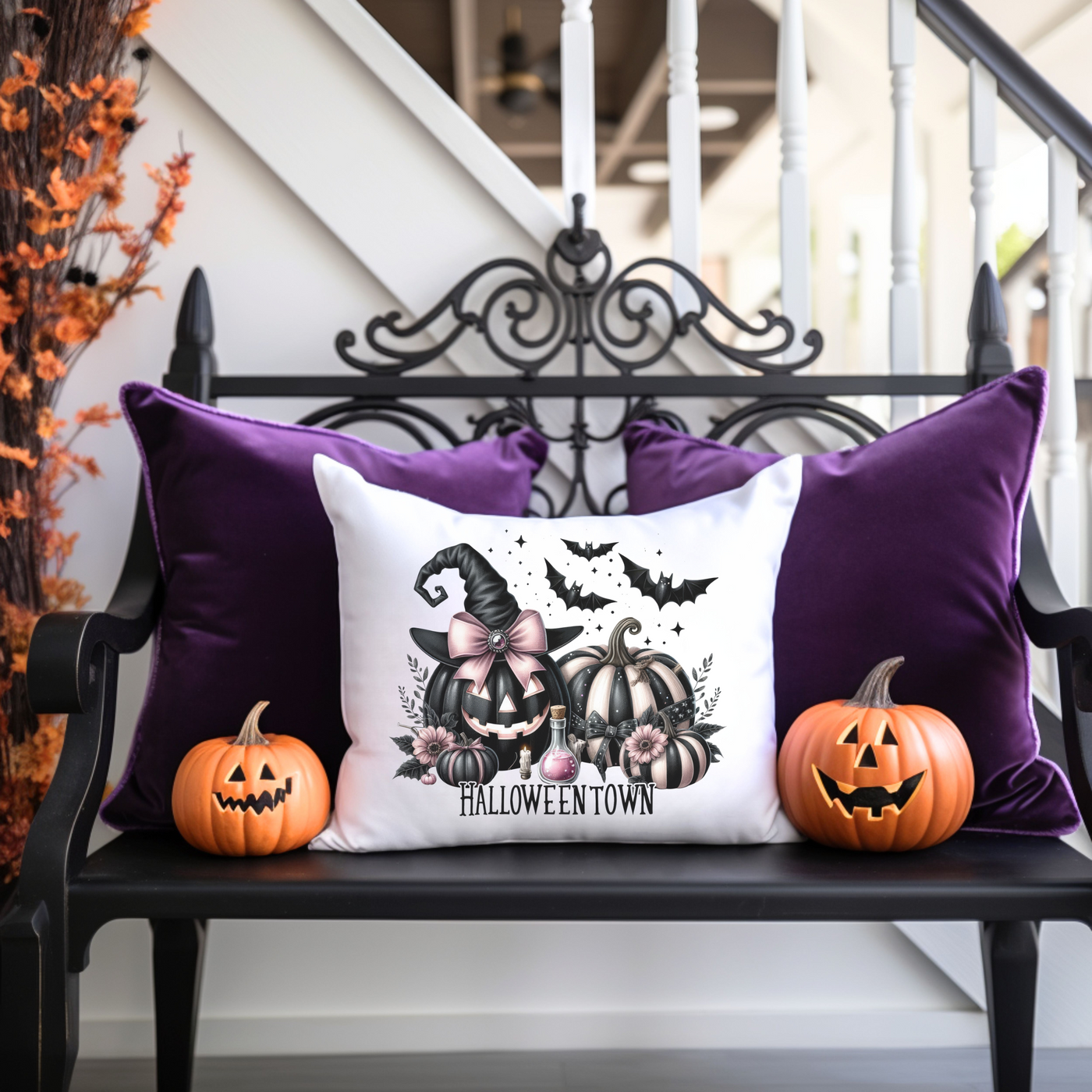 a bench with two pumpkins and a pillow on it