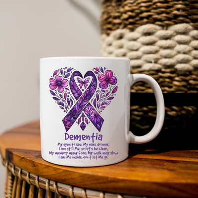 a white coffee mug with a purple ribbon on it