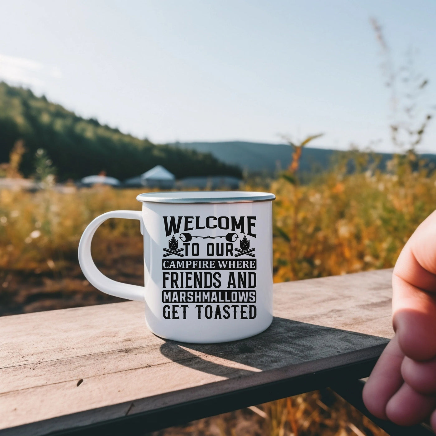 a person holding a coffee mug on a wooden table