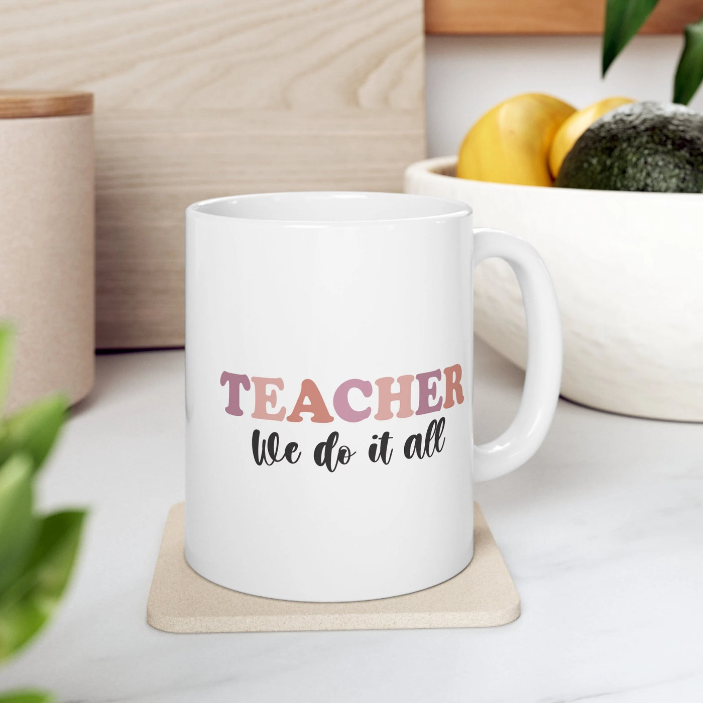 a white coffee mug that says teacher we do it all