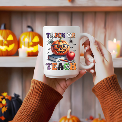 a person holding a coffee mug with a trick or treat on it