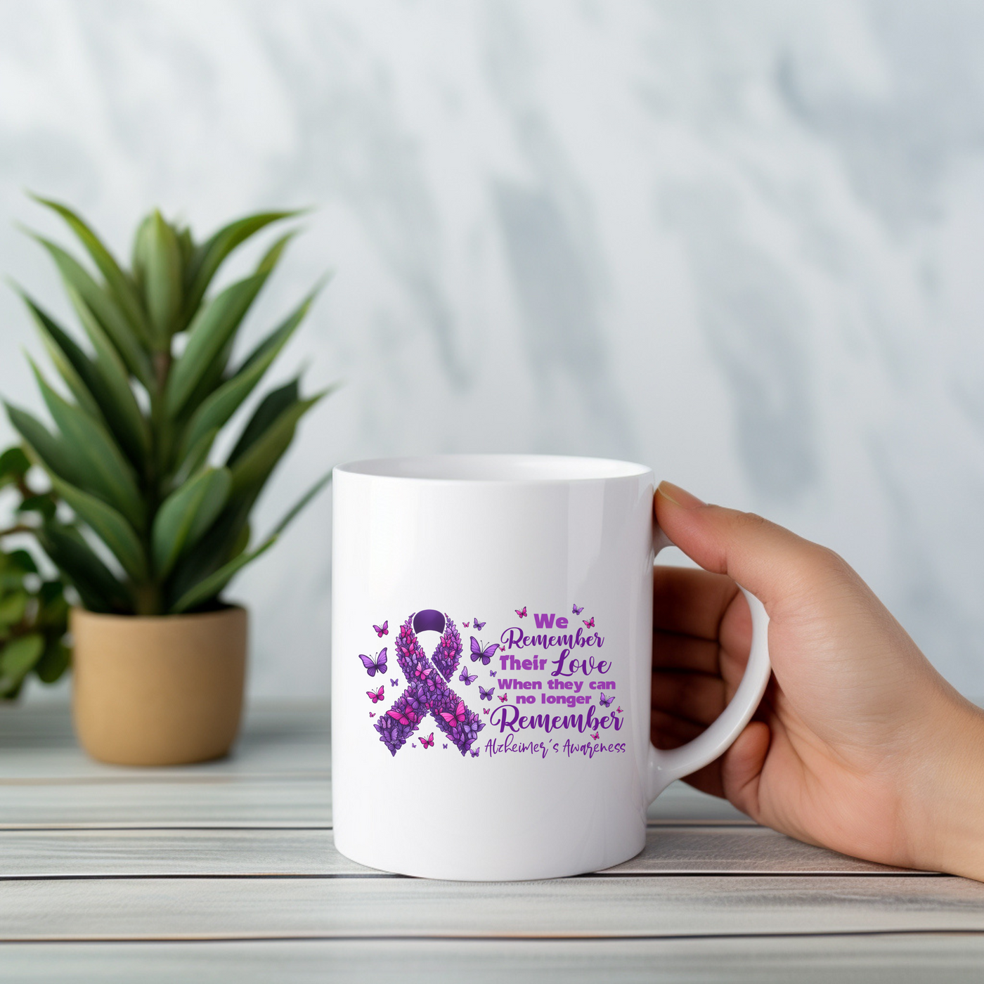 a person holding a coffee mug with a purple ribbon on it