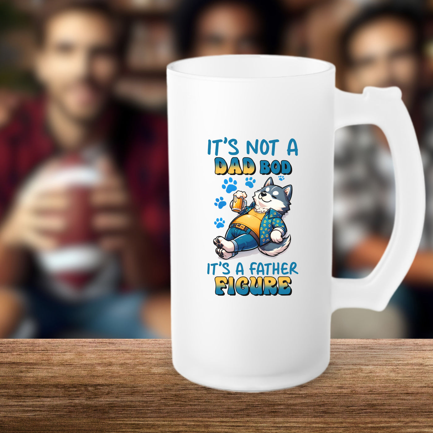 Frosted beer mug with "It's Not a Dad Bod, It's a Father Figure" design featuring a cat, set on a wooden table with blurred background.