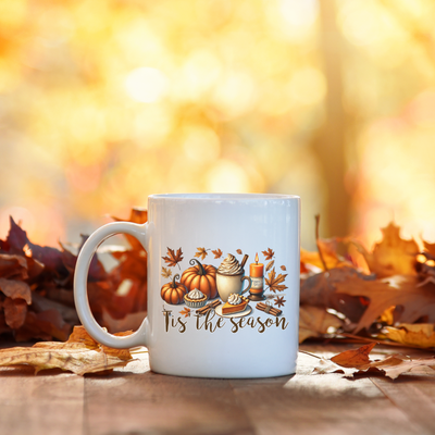 a white coffee mug sitting on top of a wooden table