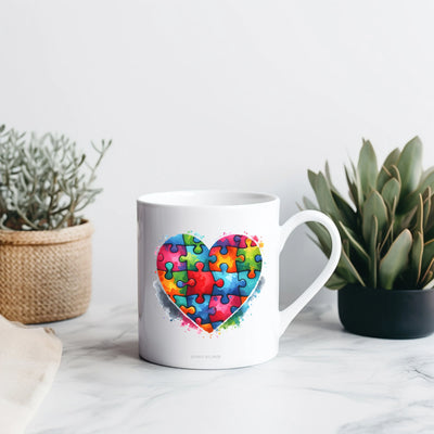 a coffee mug with a heart made of puzzle pieces