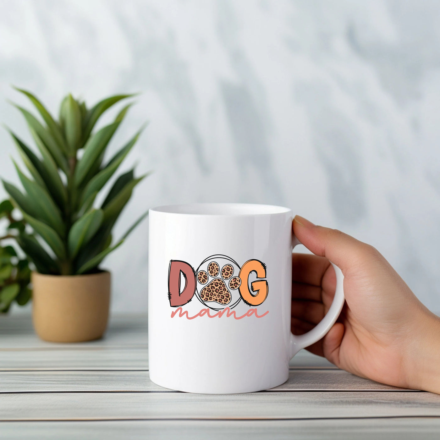 a person holding a coffee mug with a dog on it