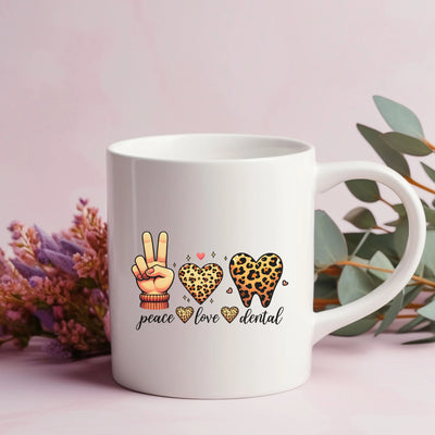 a white coffee mug with peace, love, and leopard print