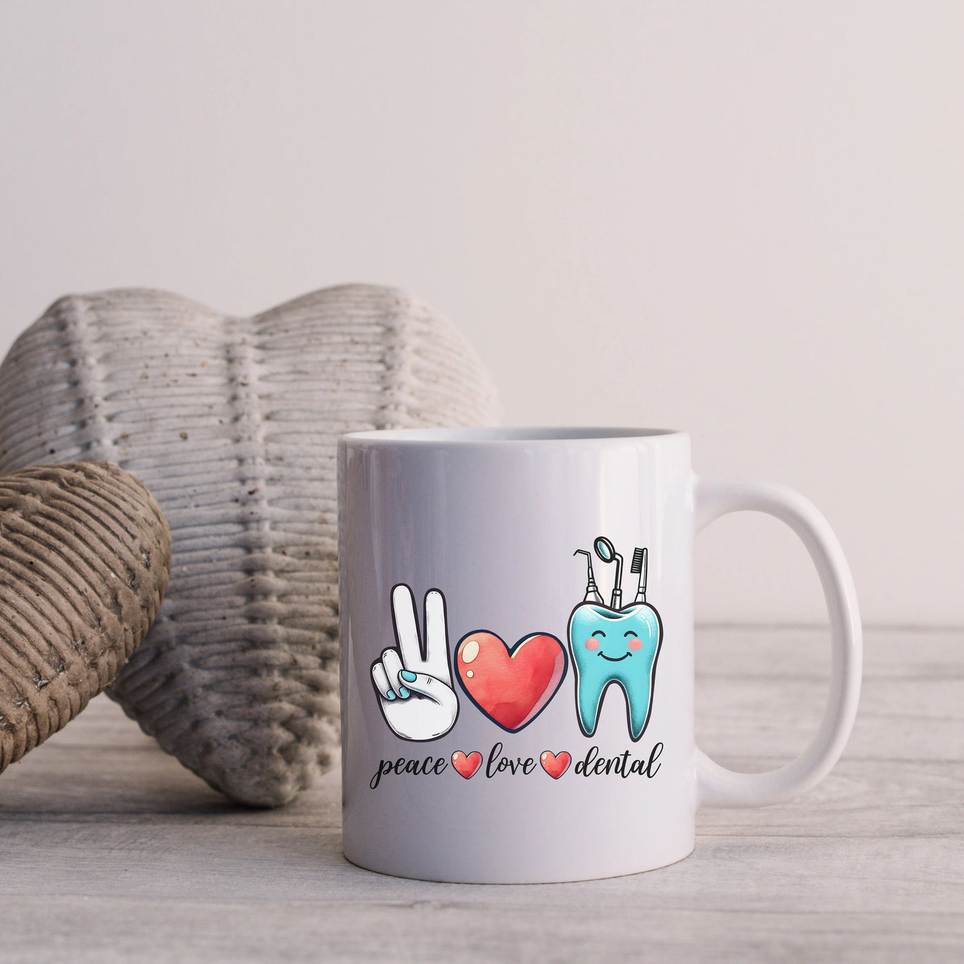 a white coffee mug with peace love dental on it