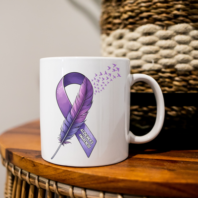 a coffee mug with a purple ribbon on it