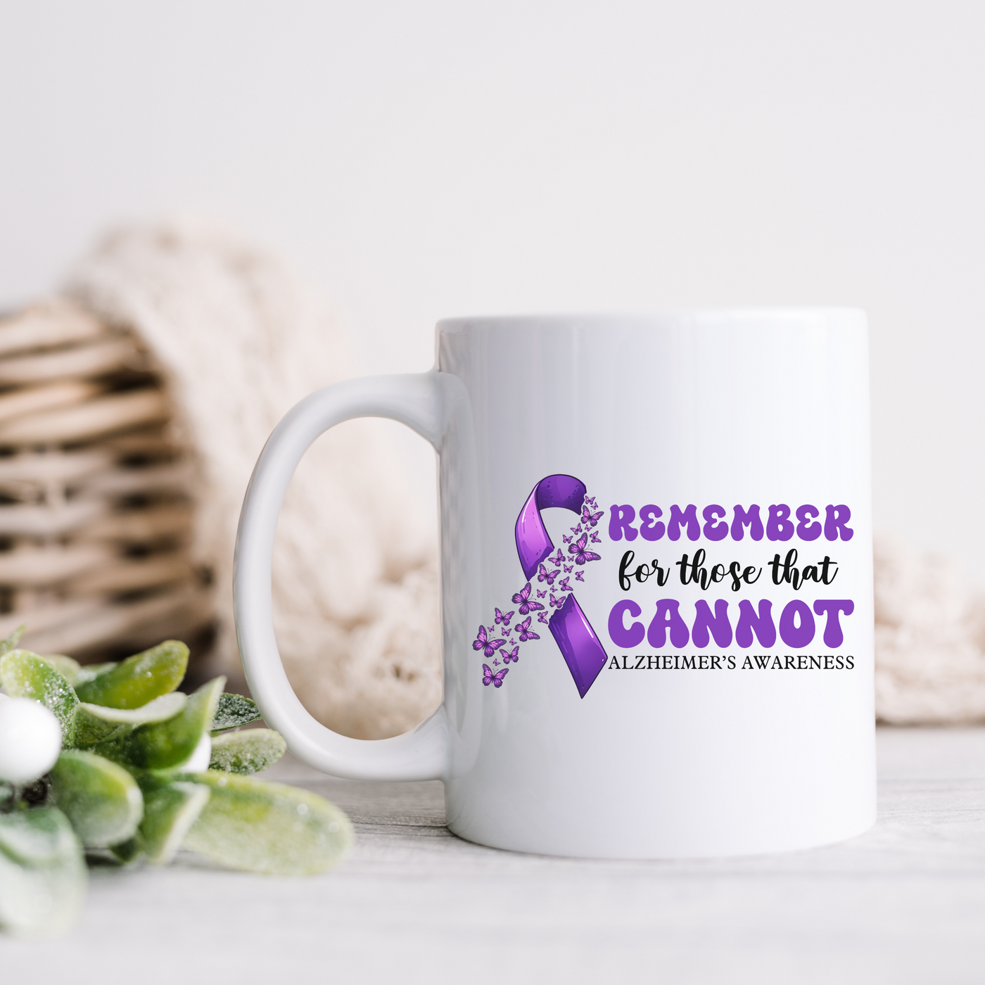 a white coffee mug with a purple ribbon on it