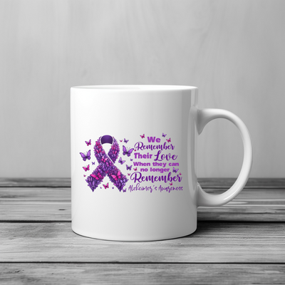 a white coffee mug with a purple ribbon on it