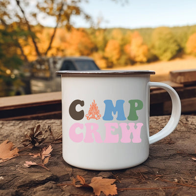 a camp crew coffee mug sitting on the ground