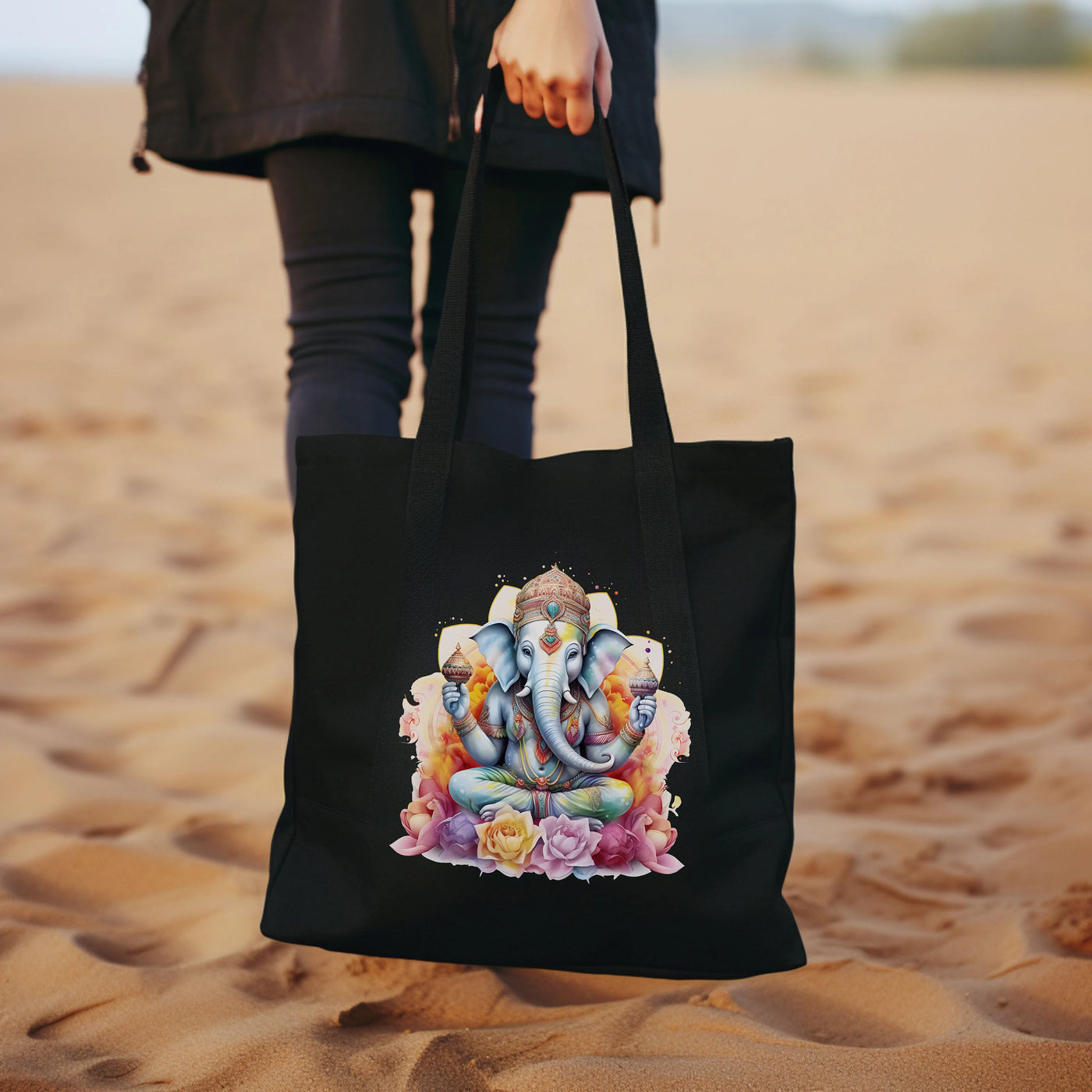 a woman carrying a black tote bag with a picture of an elephant on it