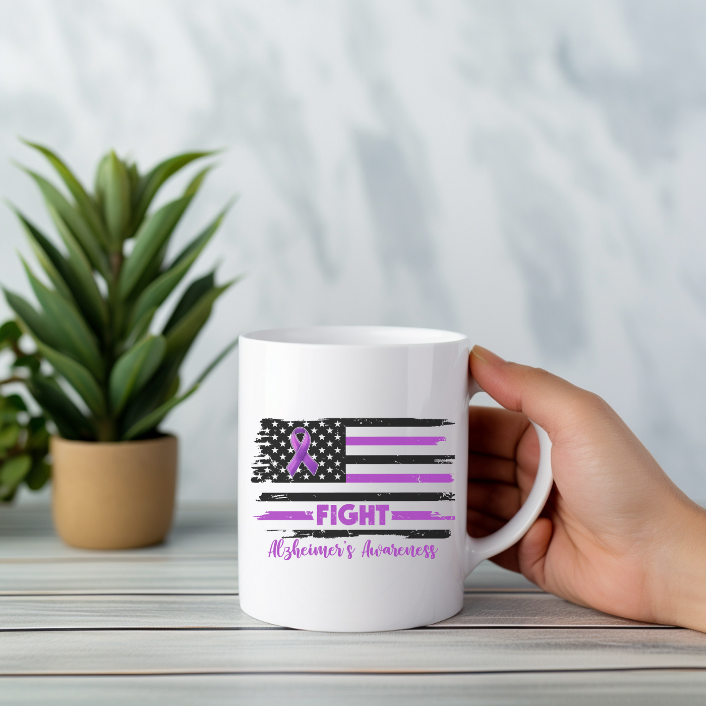 a person holding a coffee mug with a purple ribbon on it