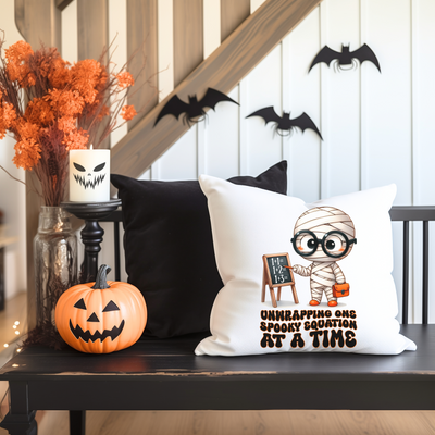 a black table topped with pillows and a vase filled with pumpkins