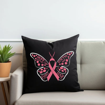 a black pillow with a pink butterfly on it