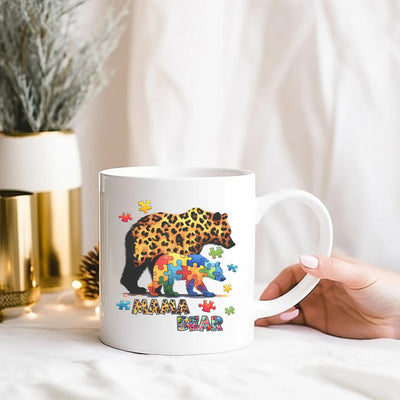 a person holding a coffee mug with a picture of a leopard on it