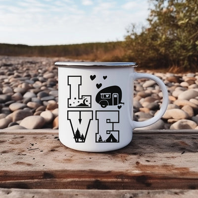 a white camper mug sitting on top of a wooden table