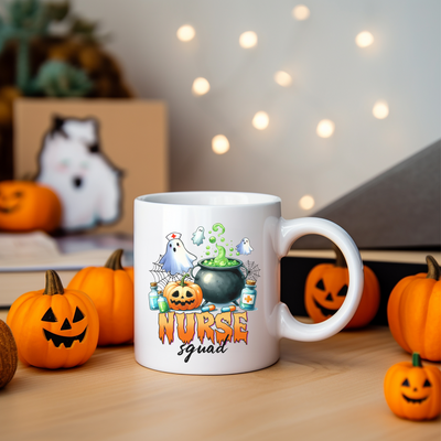 a white coffee mug with a picture of a witch and pumpkins