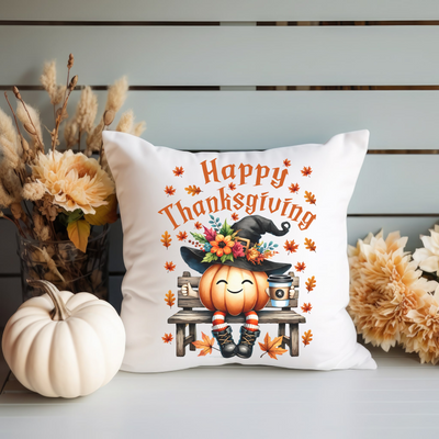 a white pillow with a happy thanksgiving pumpkin on it