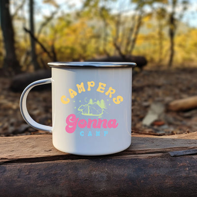 a camper's mug sitting on a log in the woods