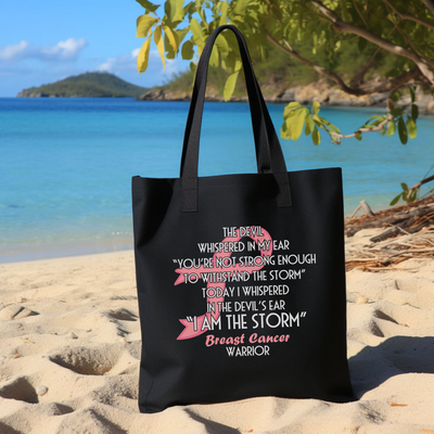 a black tote bag sitting on top of a sandy beach