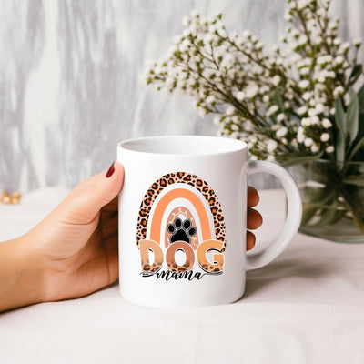 a person holding a coffee mug with a dog paw on it