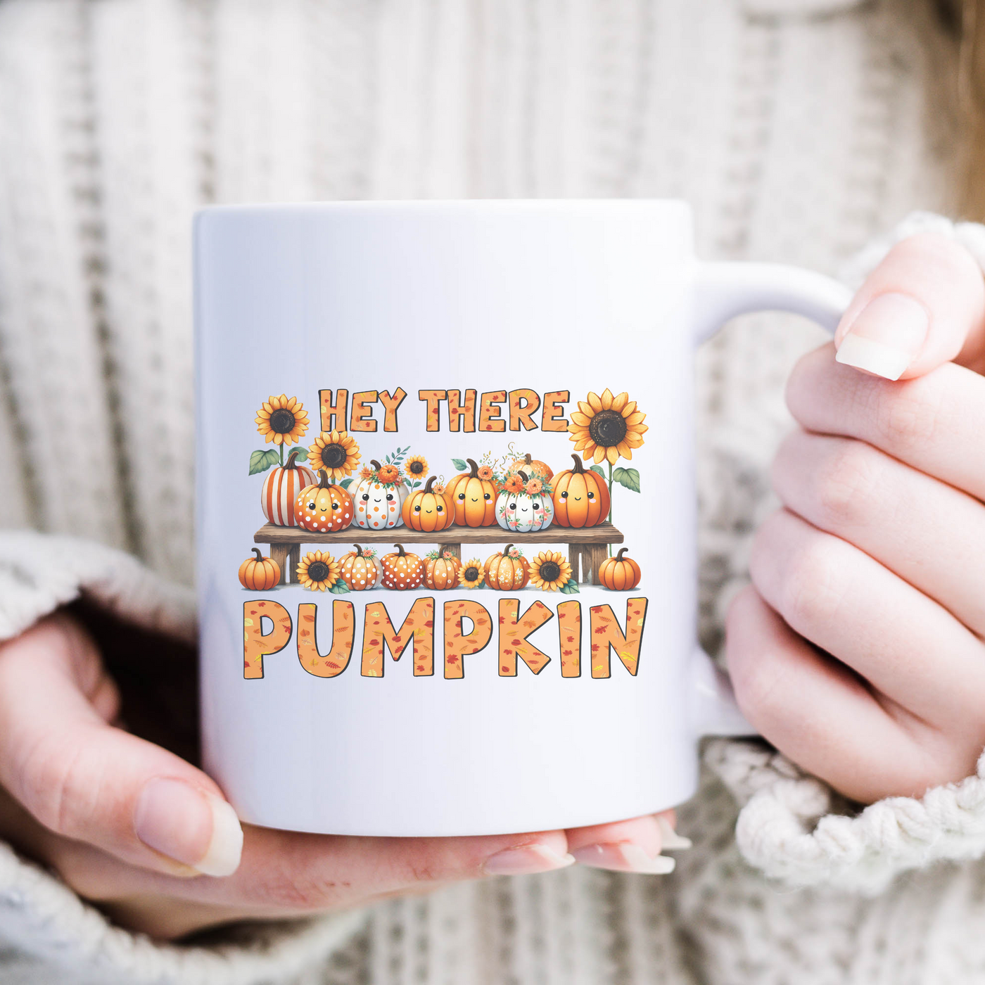 a woman is holding a coffee mug with pumpkins on it