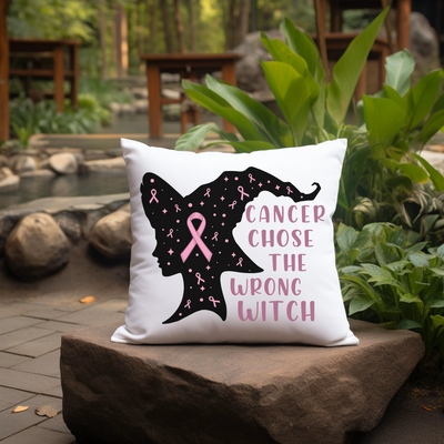 a pillow that has a pink ribbon on it