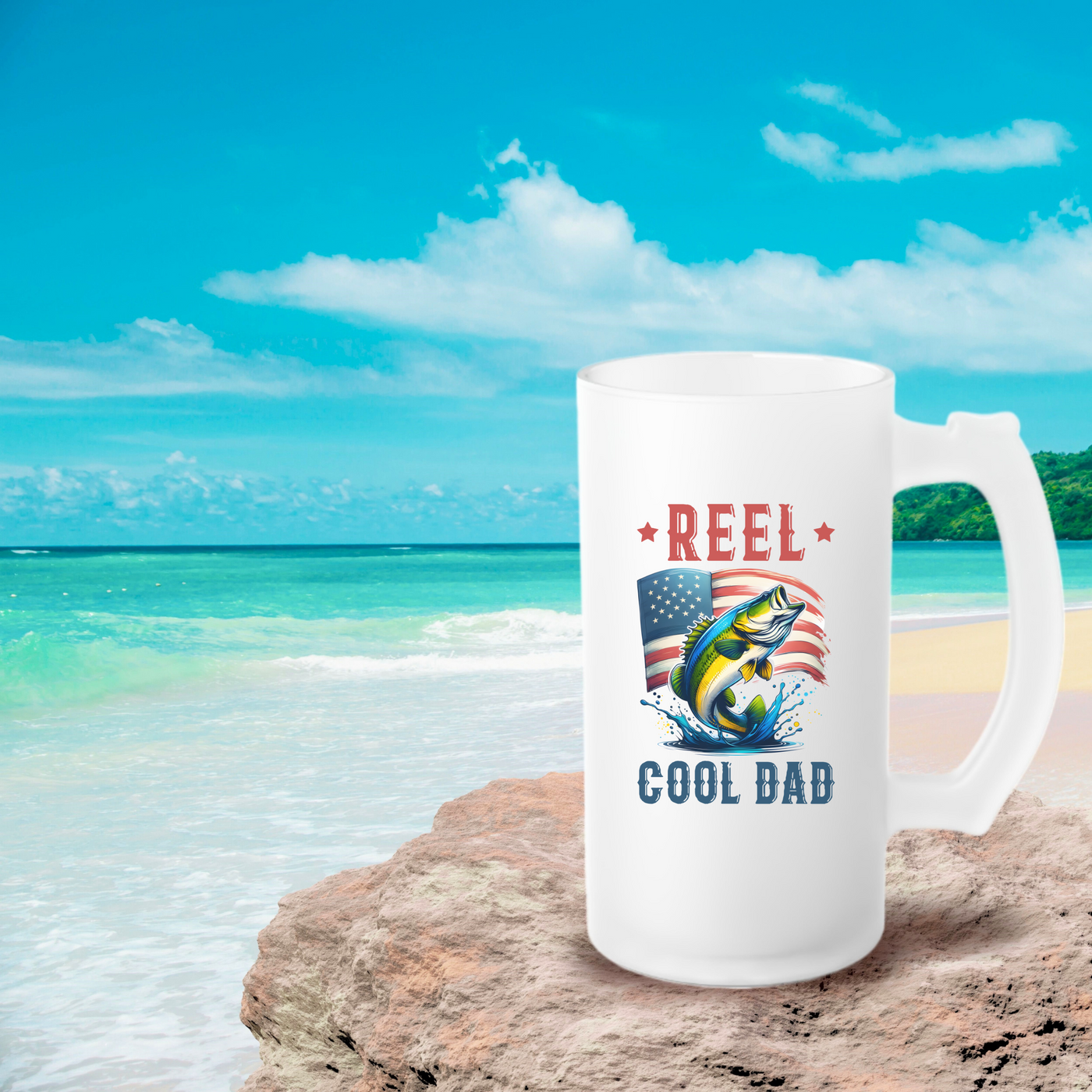 a white coffee mug sitting on top of a sandy beach