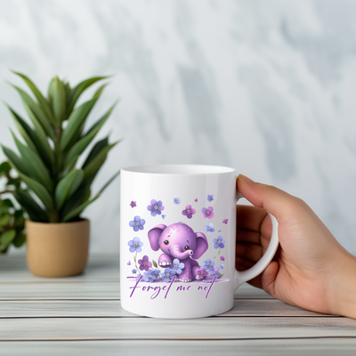 a person holding a coffee mug with an elephant on it