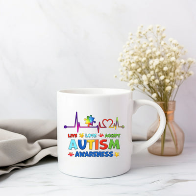 a white coffee mug with autism written on it