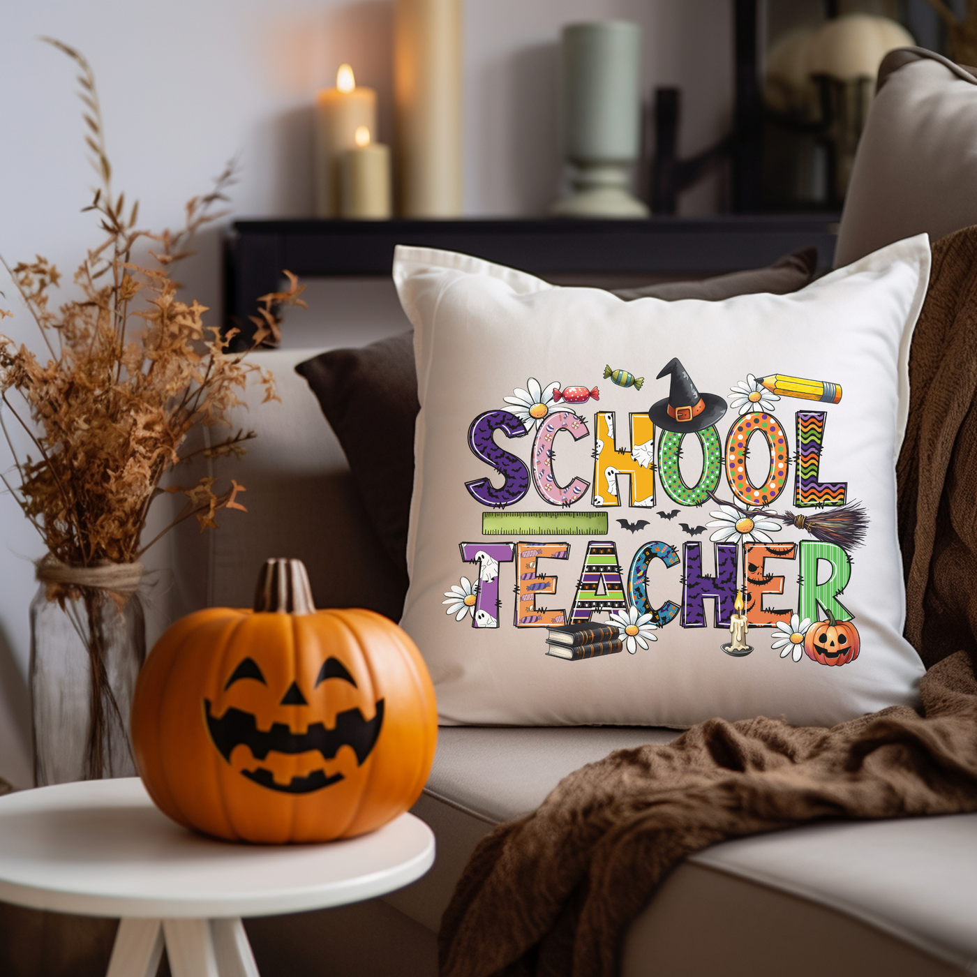 a pillow that says school teacher next to a pumpkin