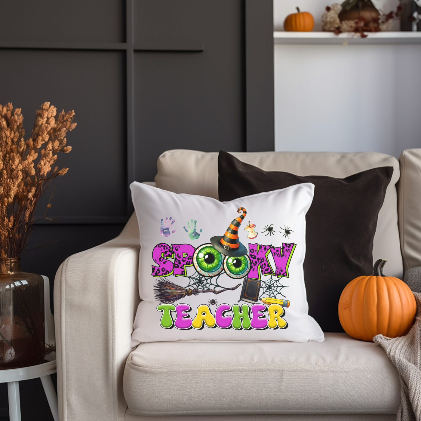 a white couch with a halloween pillow on it