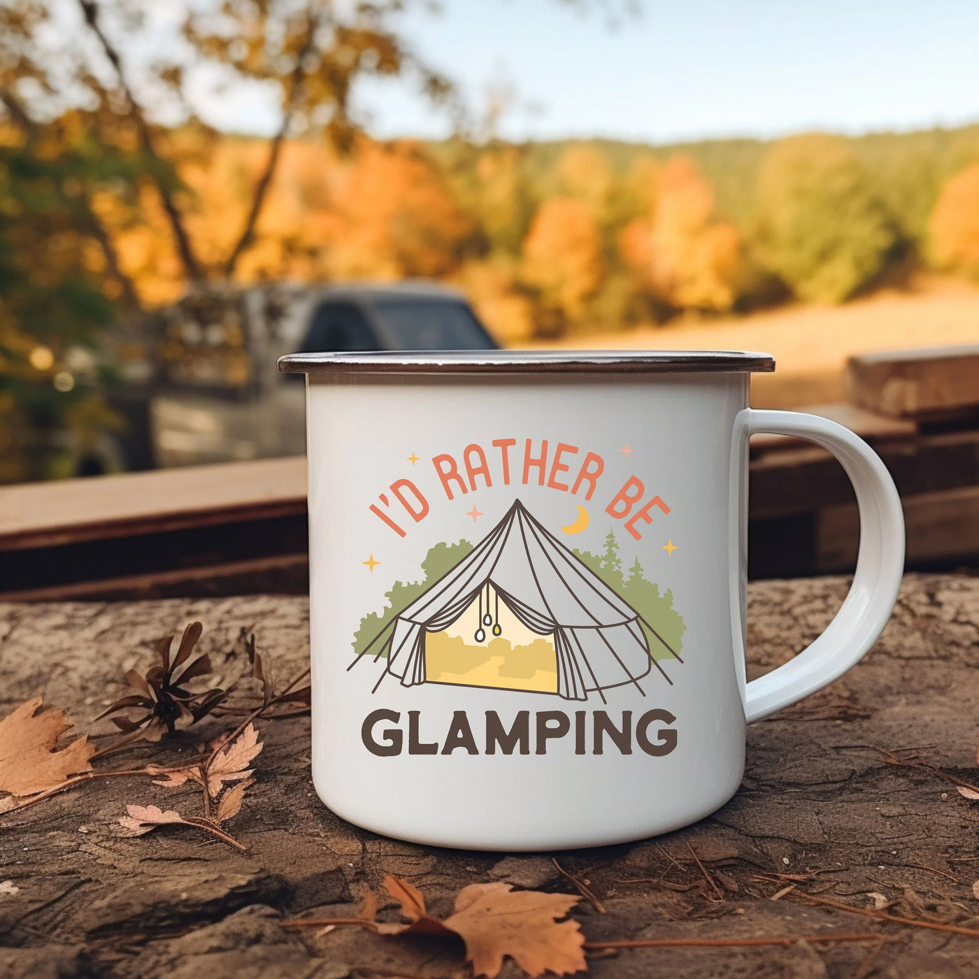 a camper mug sitting on the ground with a tent in the background