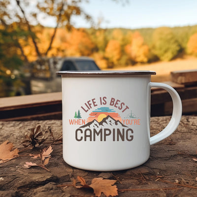 a white camper mug sitting on top of a wooden table