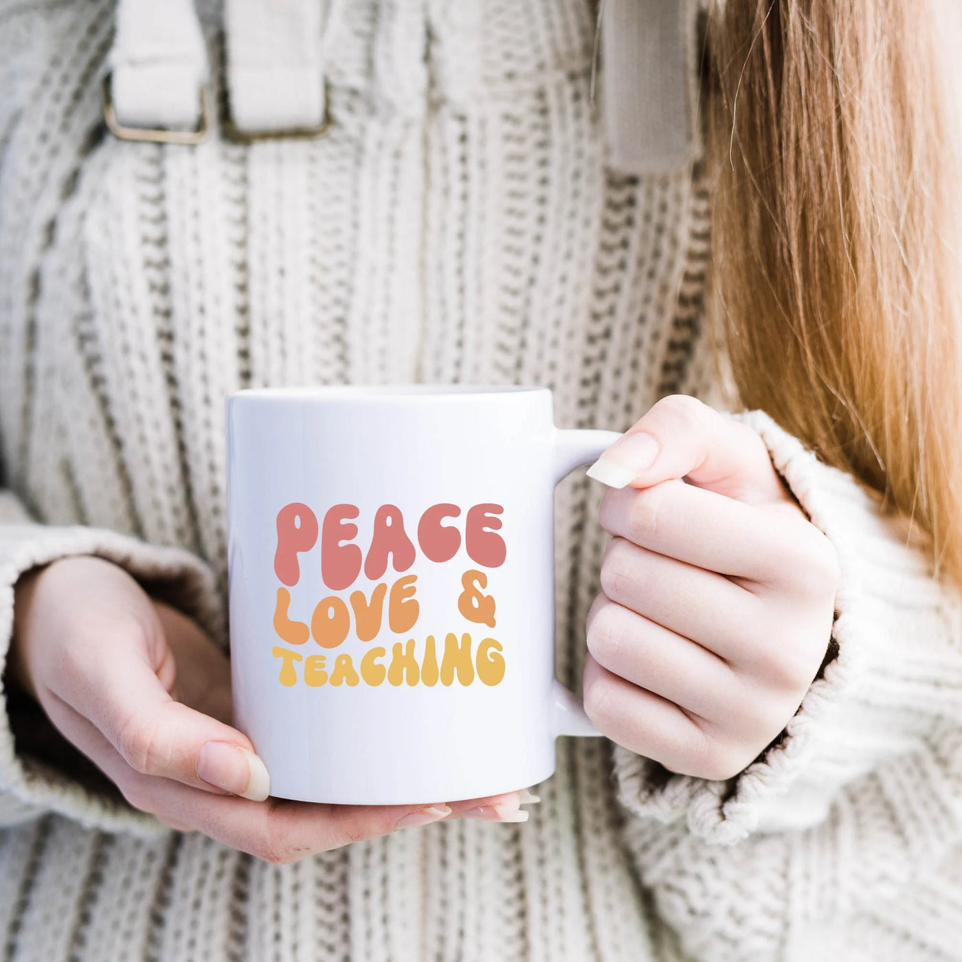 a woman holding a coffee mug with the words peace love and teaching on it